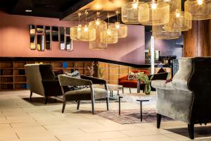 a waiting room with chairs and chandeliers at Waterfront Southport Hotel in Southport