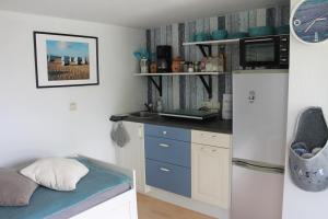 a small kitchen with a counter and a refrigerator at Lutzi´s Ferienwohnung in Rostock