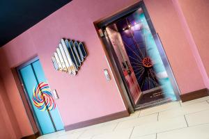 a room with a pink wall with a ferris wheel at Waterfront Southport Hotel in Southport