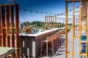 a bar with stools on the roof of a building at Waterfront Southport Hotel in Southport
