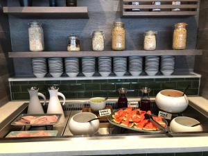 a kitchen with a sink with a plate of food at Waterfront Southport Hotel in Southport
