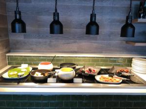 a stove top with many plates of food on it at Waterfront Southport Hotel in Southport