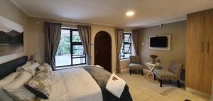 a bedroom with a bed and a large window at Dream Hills in Hillcrest