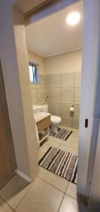 a bathroom with a toilet and a sink at Dream Hills in Hillcrest +10 photos