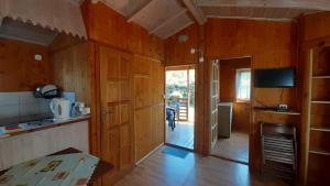 a kitchen with wooden walls and a wooden floor at 2 Bursztyny in Rusinowo