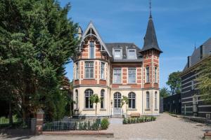 a large brick house with a tower at Bella vista in Valkenburg