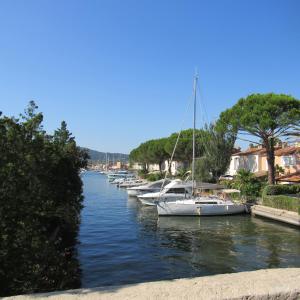 a row of boats are docked in a river at Résidence les Grimaudières in Grimaud