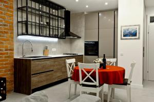 a kitchen with a table with a red table cloth at ANiMA Zagreb Luxury Apartment in Zagreb +23 photos