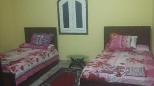 Postel nebo postele na pokoji v ubytování King Nubian House