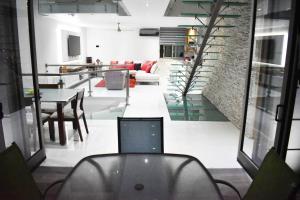 a living room with a laptop sitting on a chair at En el Centro Penthouse Lujo AC WiFi 300mbps in Aguascalientes