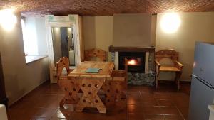 a living room with a table and a fireplace at Casa Curnet in Balme