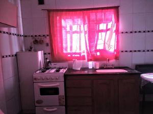 a kitchen with a pink window and a stove and a sink at Mate de luna in Buenos Aires