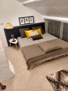 a bedroom with a large bed and a table at GOLF APARTMENT in Schilde