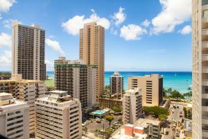 a view of a city with tall buildings and the ocean at VIVE Hotel Waikiki in Honolulu