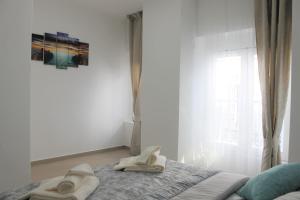 um quarto com toalhas numa cama com uma janela em Apart Baía do Sado II em Setúbal