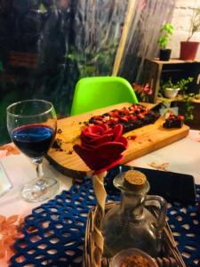 a table with a plate of food and a glass of wine at El secreto Casa Art in Montevideo