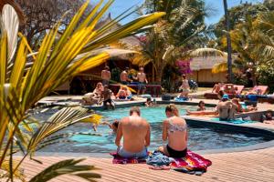 a group of people sitting in the pool at a resort at Begadang in Gili Islands