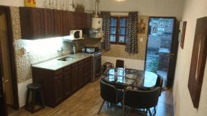 Una cocina con una mesa, un fregadero y una encimera. en Casa de descanso "El Jagüel", en San Marcos Sierras 21 fotos más