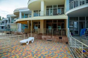 a building with a bench in front of it at Золотой Бугаз in Gribovka