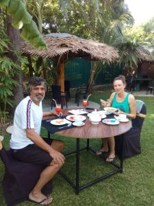 a man and a woman sitting at a table at Waterway garden in Polonnaruwa