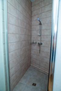 a shower with a glass door in a bathroom at Золотой Бугаз in Gribovka +27 photos