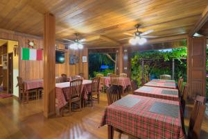 a restaurant with tables and chairs in a room at La Luna Italian Restaurant & Accommodation in Ko Lipe