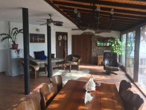 a living room with a wooden table and chairs at Villa Draganovi in Kamen Bryag +6 photos