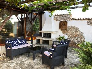a patio with two chairs and a table at Villa Draganovi in Kamen Bryag