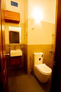 a bathroom with a toilet and a sink at Villa Agoura Grand Negombo in Negombo