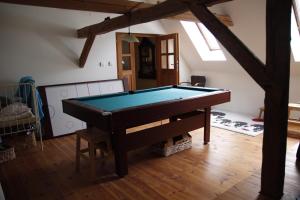 a living room with a pool table in it at Chalupa U Veverek in Mladoňov