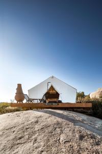 a large white tent sitting on top of a hill at Casa Misiones Glamping in Valle de Guadalupe