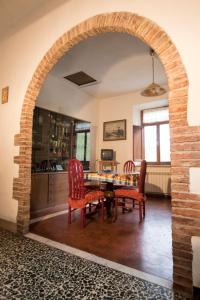 an archway in a living room with a table and chairs at Rustic Tuscan Apartment in Massa Marittima