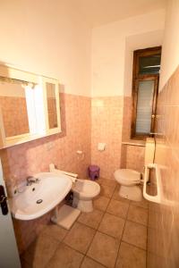 a bathroom with a sink and a toilet at Rustic Tuscan Apartment in Massa Marittima