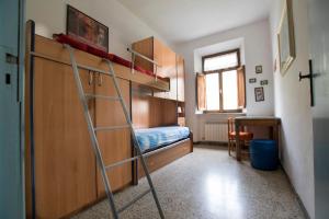 a bedroom with a bunk bed with a ladder at Rustic Tuscan Apartment in Massa Marittima