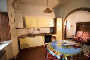 a kitchen and dining room with a table and chairs at Rustic Tuscan Apartment in Massa Marittima