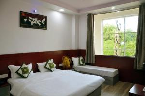 sypialnia z 2 łóżkami i oknem w obiekcie Meera Mahal w mieście Sawai Madhopur
