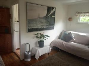 a living room with a couch and a picture on the wall at Private house Parking Garden Sea Nature in Malmö