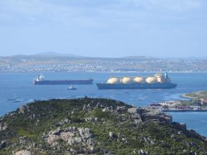 three cargo ships in the water next to a island at Berg en Dal Accommodation in Saldanha