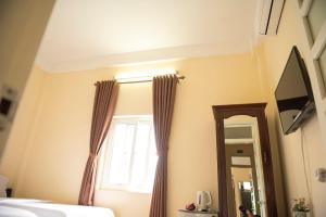 TV a/nebo společenská místnost v ubytování Minh Tam Guesthouse + 15 fotografií