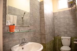 a bathroom with a sink and a toilet at Minh Tam Guesthouse in Hue