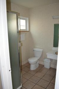 a bathroom with a toilet and a sink at Gateway Inn Fairfield in Fairfield