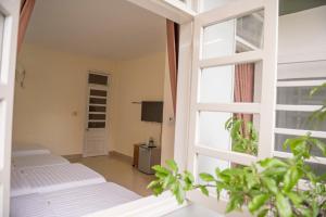 Postel nebo postele na pokoji v ubytování Minh Tam Guesthouse