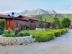 a house with a yard with a stone wall at Agriturismo Il Timo in Magliano deʼ Marsi