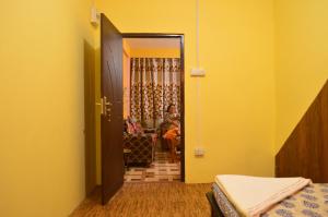 a bedroom with a door open to a living room at Banabas Homestay in Darjeeling