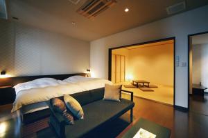 a hotel room with a large bed and a large window at AMANE resort SEIKAI in Beppu