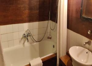 a bathroom with a tub and a toilet and a sink at Le Dupleix in Pondicherry