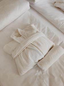 a white towel sitting on top of a bed at Family Hel in Hel