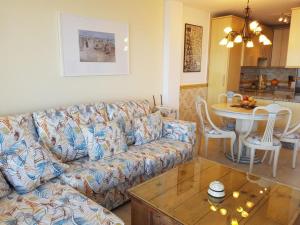 a living room with a couch and a table at Garden sea view apartment near beach in Mijas Costa