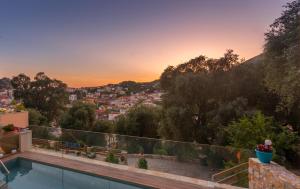 a villa with a swimming pool and a view of a city at Villa Douros in Parga