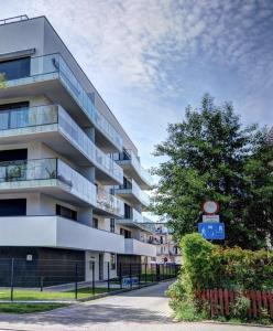 an apartment building with a sign in front of it at Family Hel in Hel